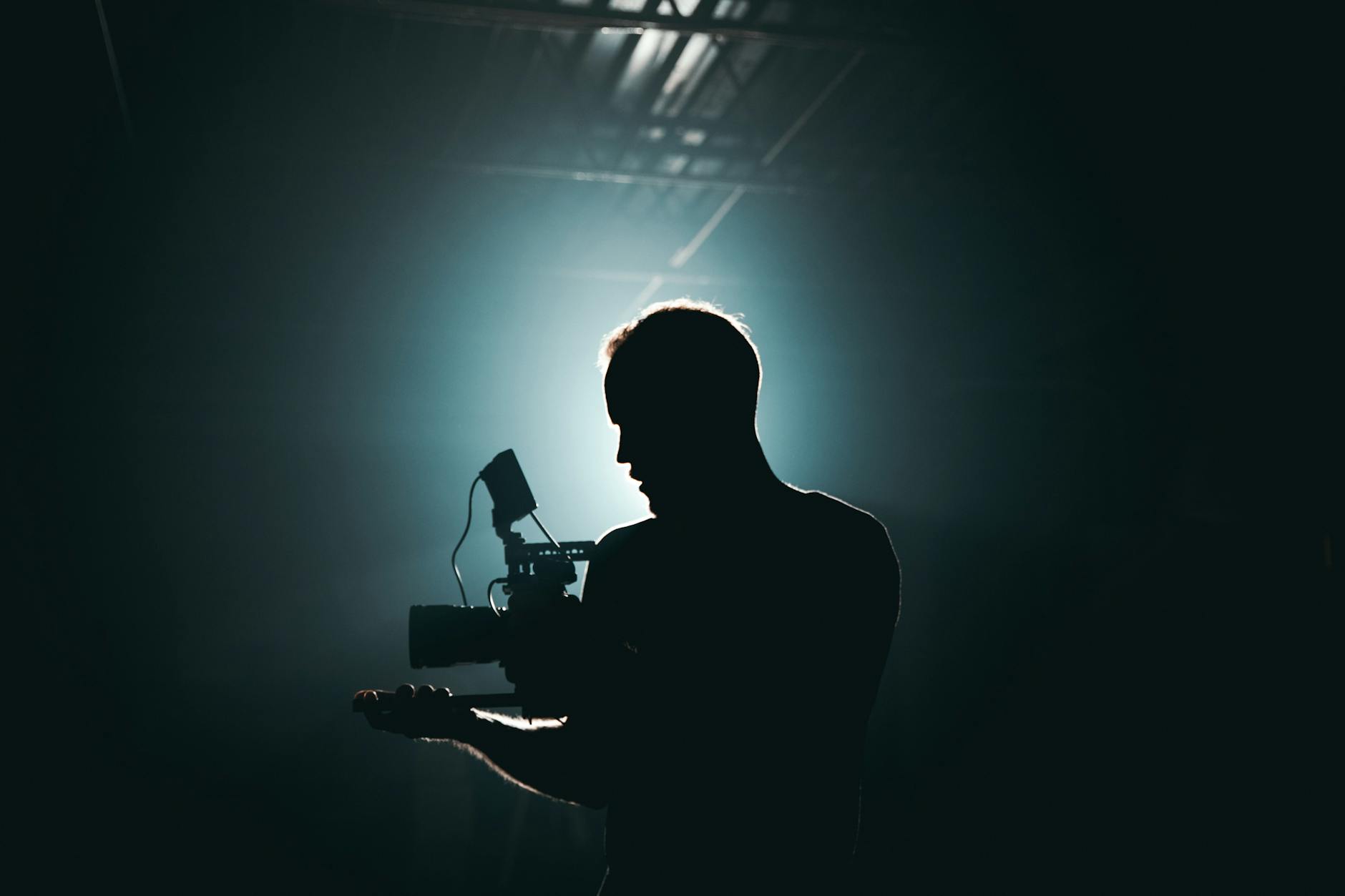 https://www.pexels.com/photo/silhouette-of-man-standing-in-front-of-microphone-3379934/